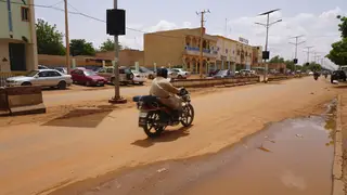 A lone motorcyclist rides in Niamey, Niger