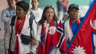 Norwegian mountain climber Kristin Harila, centre, and her Nepali Sherpa guide Tenjen Sherpa, right, who on Thursday set a new record by scaling the world’s 14 highest peaks in 92 days arrive at the a