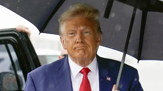 Donald Trump carrying an umbrella