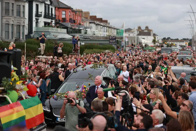 Fans of singer Sinead O'Connor line the streets for a 'last goodbye' to the Irish singer as her funeral cortege passes through her former hometown of Bray, Co Wicklow, ahead of a private burial service. Picture date: Tuesday August 8, 2023.