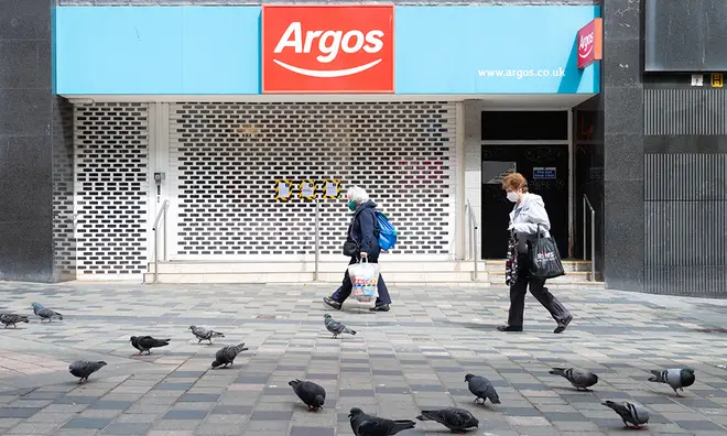 A closed Argos with the shutters down on an empty high street