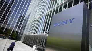 People walk past the headquarters of Sony in Tokyo