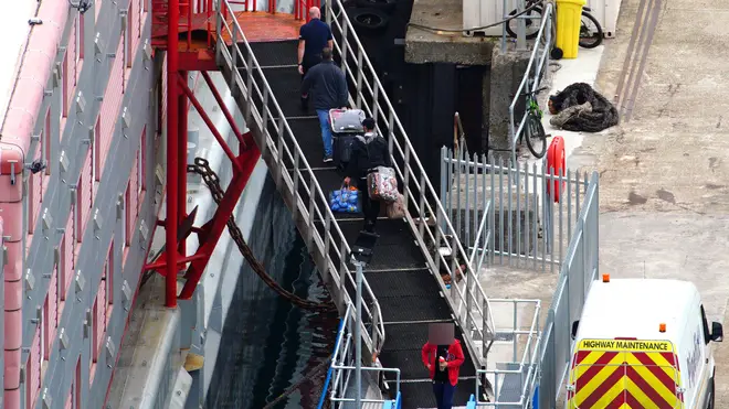 People thought to be asylum seekers boarding the Bibby Stockholm accommodation barge