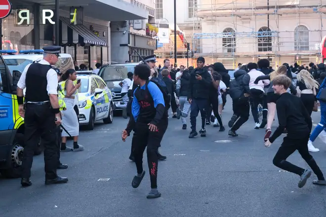 Police and large groups of young people in Oxford Circus hours after the mass TikTok crime was due to take place.