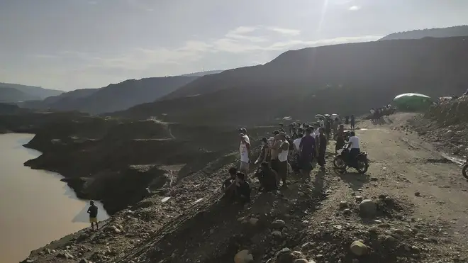 Miners, rescuers and local residents at the site of the jade mine landslide