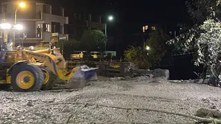 An excavator removes mud and debris