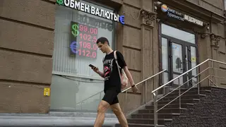 A man walks past a currency exchange in Moscow