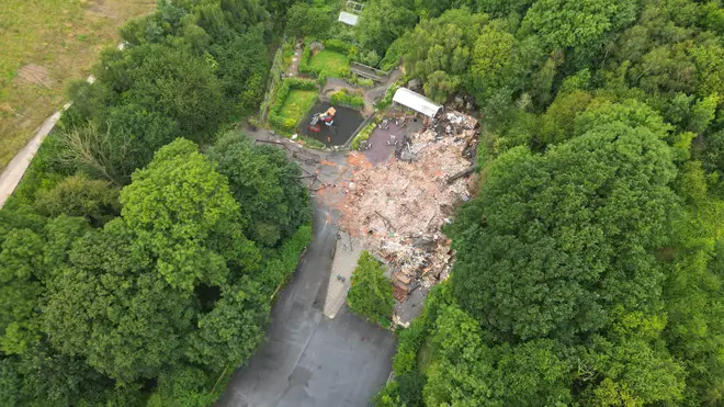 The remains of The Crooked House pub near Dudley which has been demolished two days after it was gutted by fire.