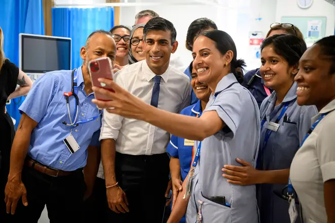 The prime minister posed for selfies with hospital staff