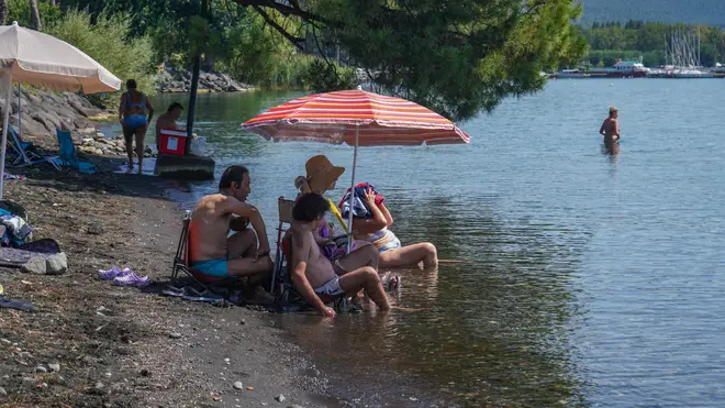People escape the summer heat on lake Bolsena in Central Italy