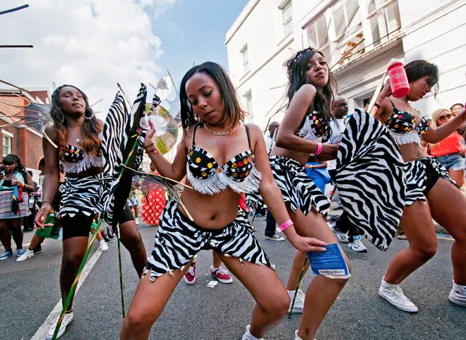 Group of young people dancing  in the parade at Notting Hill Carnival