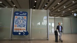 A traveller walks through the international flight arrivals area at Beijing Capital International Airport