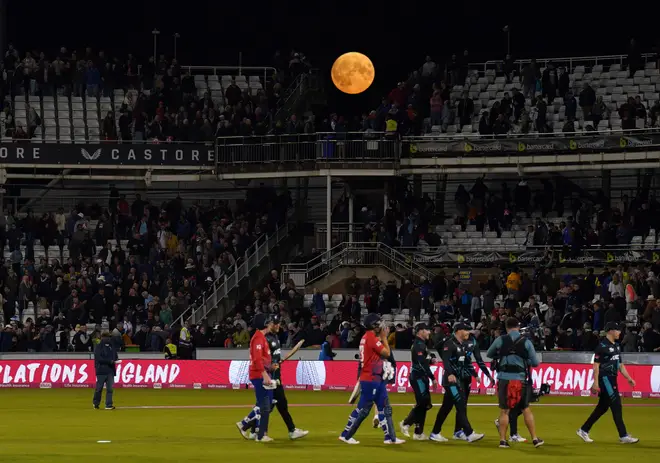 The super blue moon is visible over the stands at a T20 cricket match in Durham