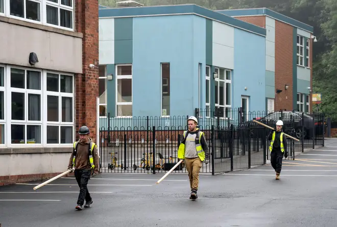 Workmen at Abbey Lane Primary School in Sheffield, which has been affected with sub standard reinforced autoclaved aerated concrete
