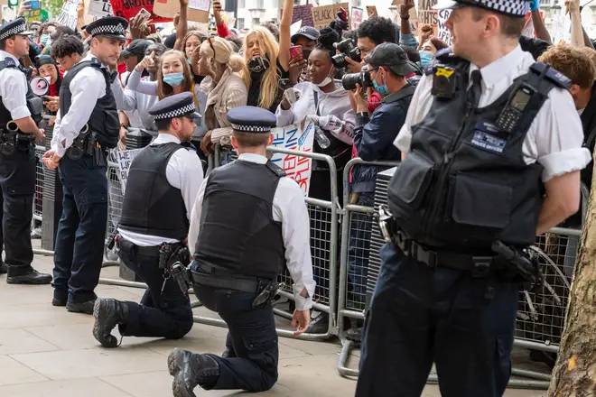 A police officer takes the knee during a Black Lives Matter protest in London