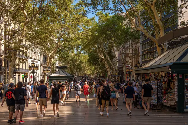 Lord Rose said Brexit had damaged the nation's prosperity - picture shows people enjoying the sun on Las Ramblas in Barcelona