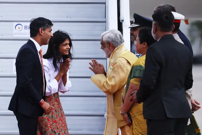 Prime Minister Rishi Sunak and wife Akshata Murty are met on the tarmac by dignitaries