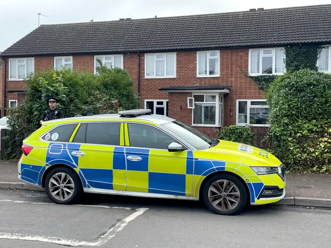 Police outside a flat in Stonnall, Staffordshire, yesterday. The victim of the dog attack has died