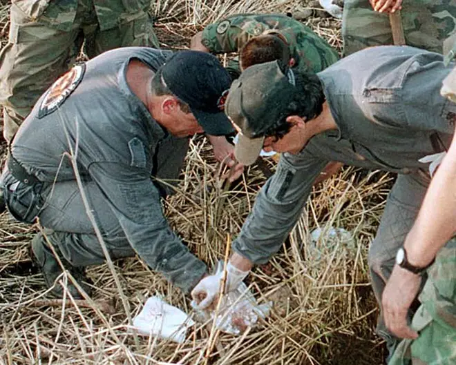 Investigators working at one of Garavito's mass graves