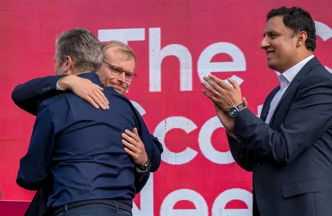 Labour leader Sir Keir Starmer gives new Labour MP for Rutherglen and Hamilton West Michael Shanks a hug as Scottish Labour leader Anas Sarwar looks on