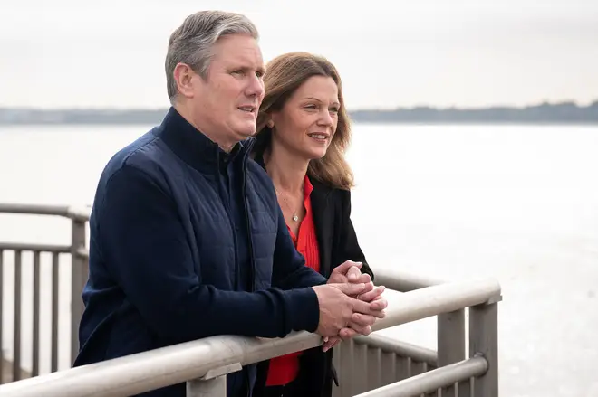 Britain's main opposition Labour Party leader Keir Starmer and his wife Victoria pose for a photograph as they walk by the River Mersey in Liverpool