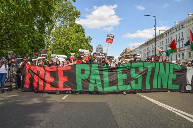 Protesters march with placards and a 'Free Palestine' banner in Knightsbridge