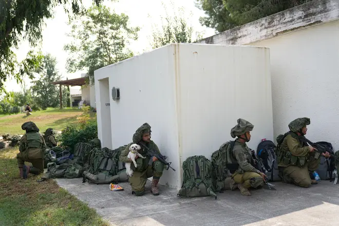 Israeli soldiers deploy in kibbutz Kfar Azza on Tuesday, Oct. 10, 2023.