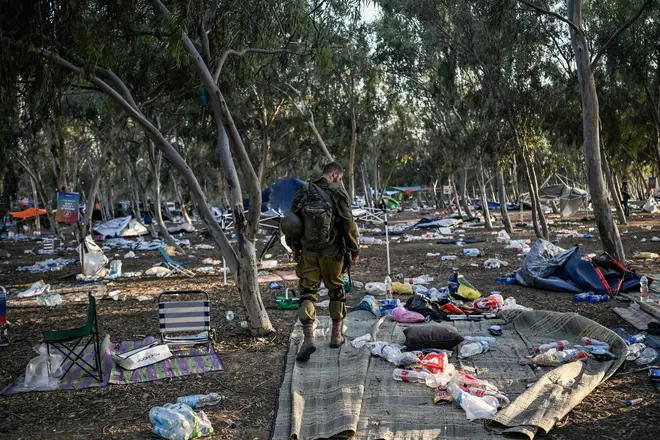 An Israeli soldier patrols on October 12, 2023 near Kibbutz Beeri, the place where 270 revellers were killed by militants during the Supernova music festival