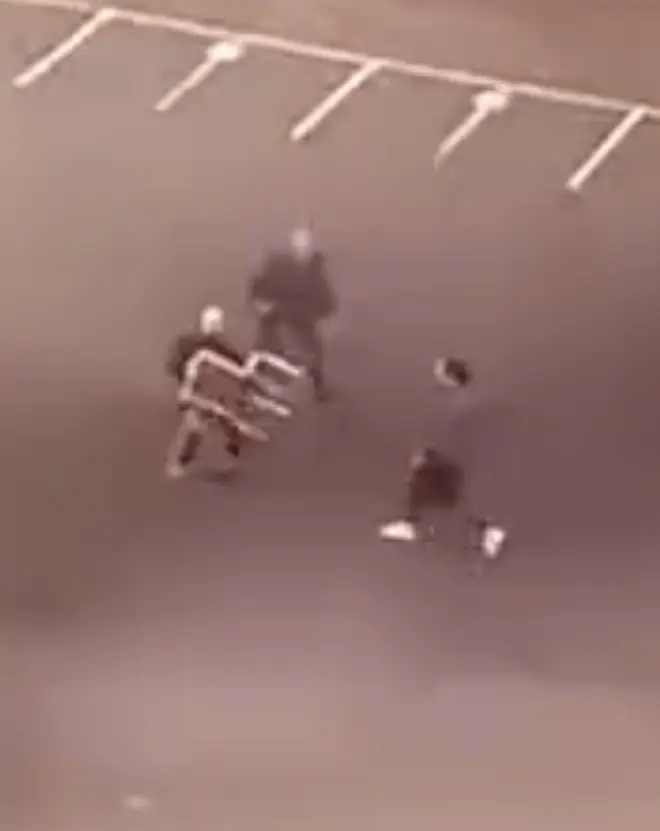 One of the victims tries to keep the attacker at bay with a chair