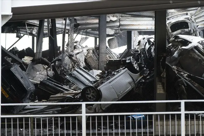 The wreckage of cars after the fire caused the car park to collapse
