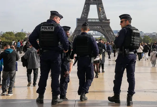 Police officers patrol the Trocadero plaza near the Eiffel Tower on Tuesday