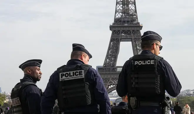 Police officers patrol the Trocadero plaza near the Eiffel Tower