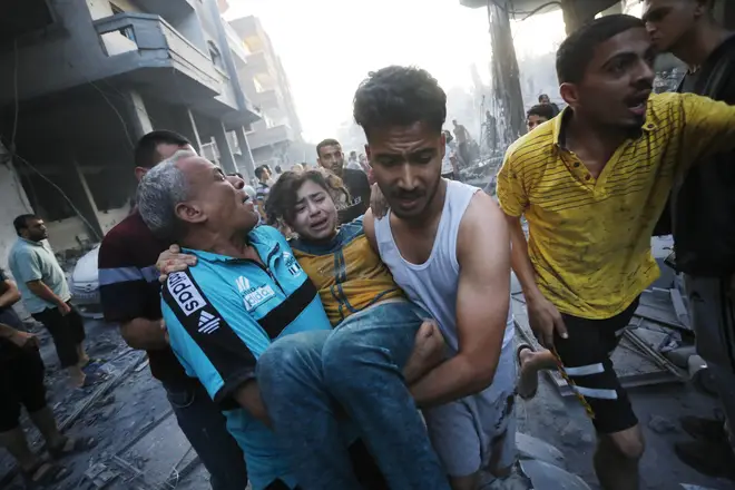People carry an injured Palestinian child on Wednesday