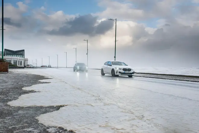 Sea foam covers the shore and promanade on Aberdeen Beach Scotland during Storm Babet