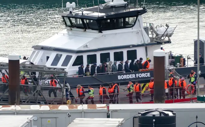 A group of people thought to be migrants are brought in to Dover on Monday