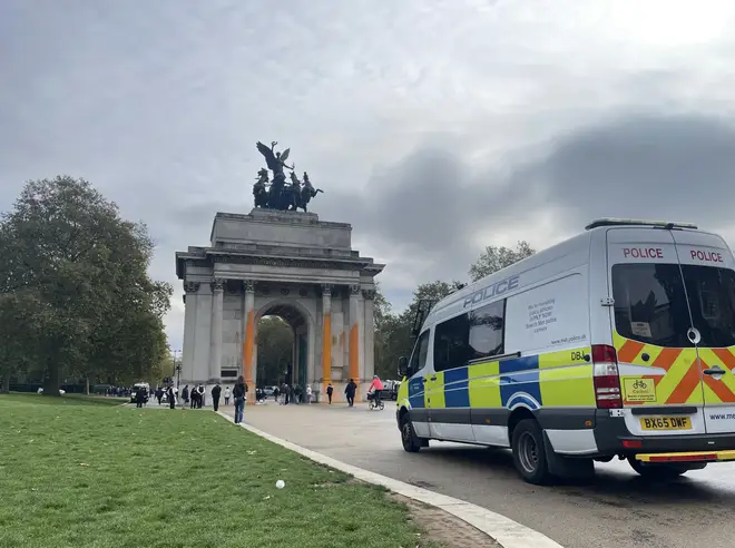 Police at the scene after the arch was sprayed with orange paint