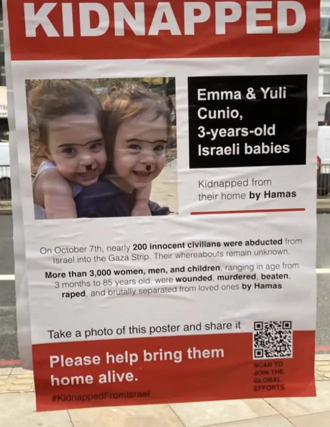 This poster of Israeli children was defaced with Hitler moustaches