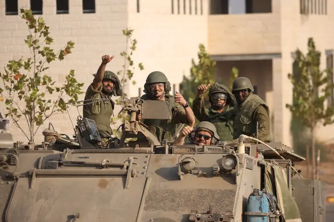 Israeli tanks and troops move near the border with Gaza