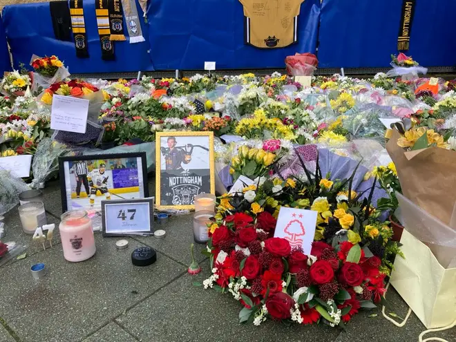 Fans left tributes to the ice hockey star outside Motorpoint Arena in Nottingham.
