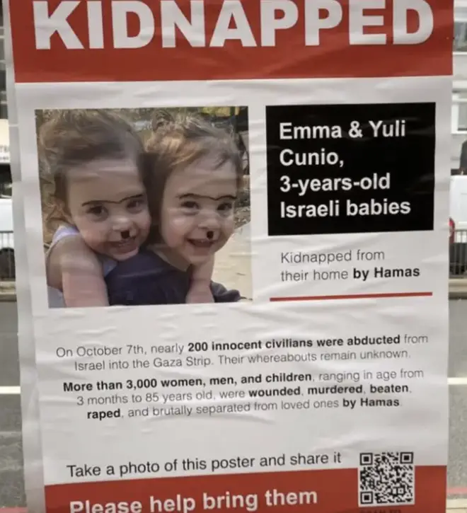 This poster of Israeli children was defaced with Hitler moustaches.