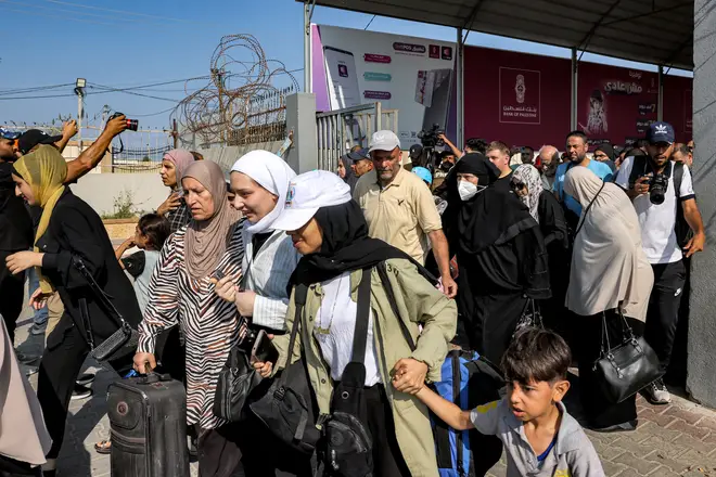People walk through a gate to enter the Rafah border crossing to Egypt in the southern Gaza Strip