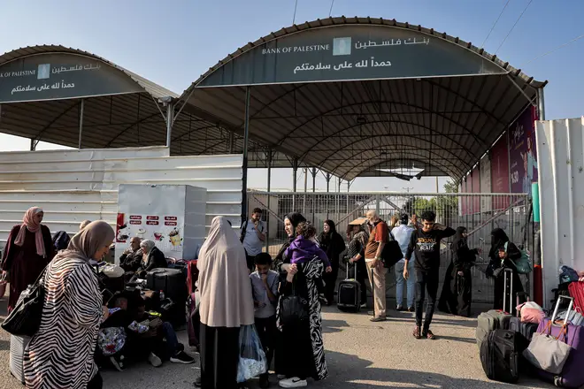People wait at the Rafah crossing out of Gaza