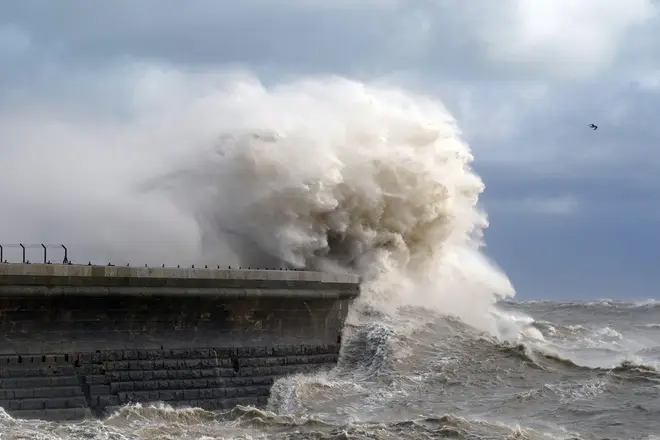 Waves crash over Dover harbour wall