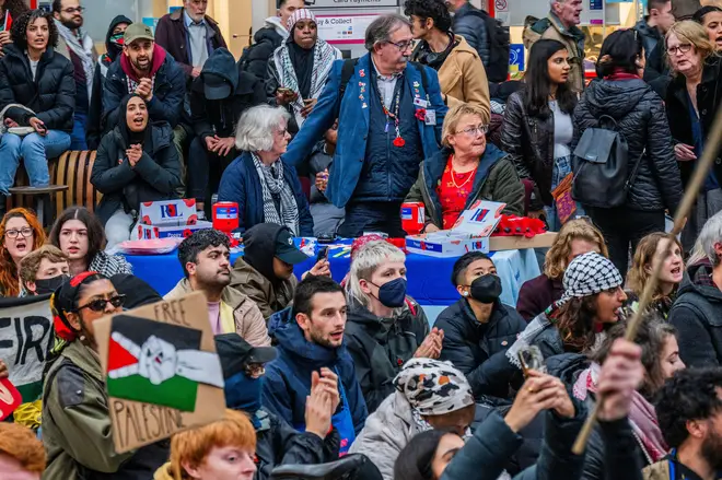 Royal British Legion Poppy sellers look unimpressed, it seeems as pro-Palestine protesters occupy Charing Cross station