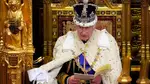 Britain's King Charles III, wearing the Imperial State Crown and the Robe of State, reads the King's speech from The Sovereign's Throne in the House of Lords chamber, during the State Opening of Parliament