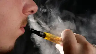 Man vaping - smoking an electronic cigarette / e-cigarette
