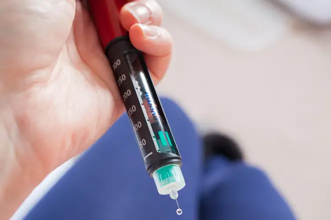 A close-up of the slow acting insulin Levemir on the tip of an insulin pen.