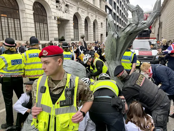 Police officers take Extinction Rebellion activists into custody after they chained themselves to a setup they made suddenly set up during the 800-year old traditional Lord Mayor's Show in London, United Kingdom on November, 13, 2021