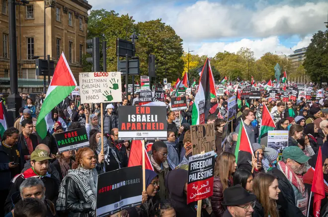 Hundreds of thousands of pro-Palestinian protesters march with placards and flags