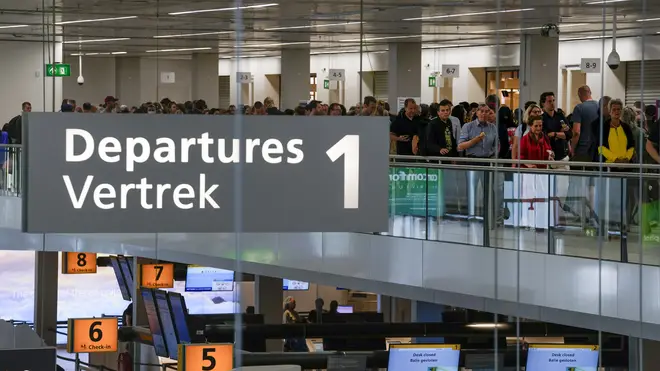 Travellers wait to check in and board flights at Amsterdam’s Schiphol Airport, Netherlands